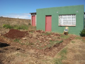 The foundations dug for extra 2 rooms with house in background