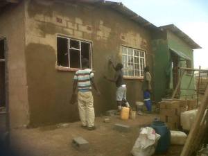 Guys plastering the house