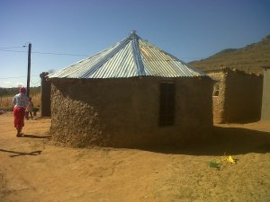 Tholakele's roofing sorted on her mud hut.