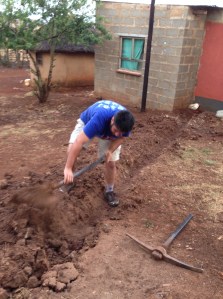 Salvador digging a trench for electricity
