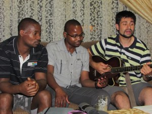 Kingsley, Clayton and Salvador sing at Kingsley's house. 
