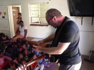 John teaches the children a new song
